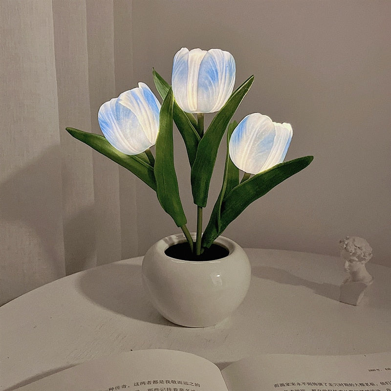 Blue tulip night light blooms in a white ceramic pot with cool LED glow