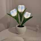 Blue tulip night light blooms in a white ceramic pot with cool LED glow