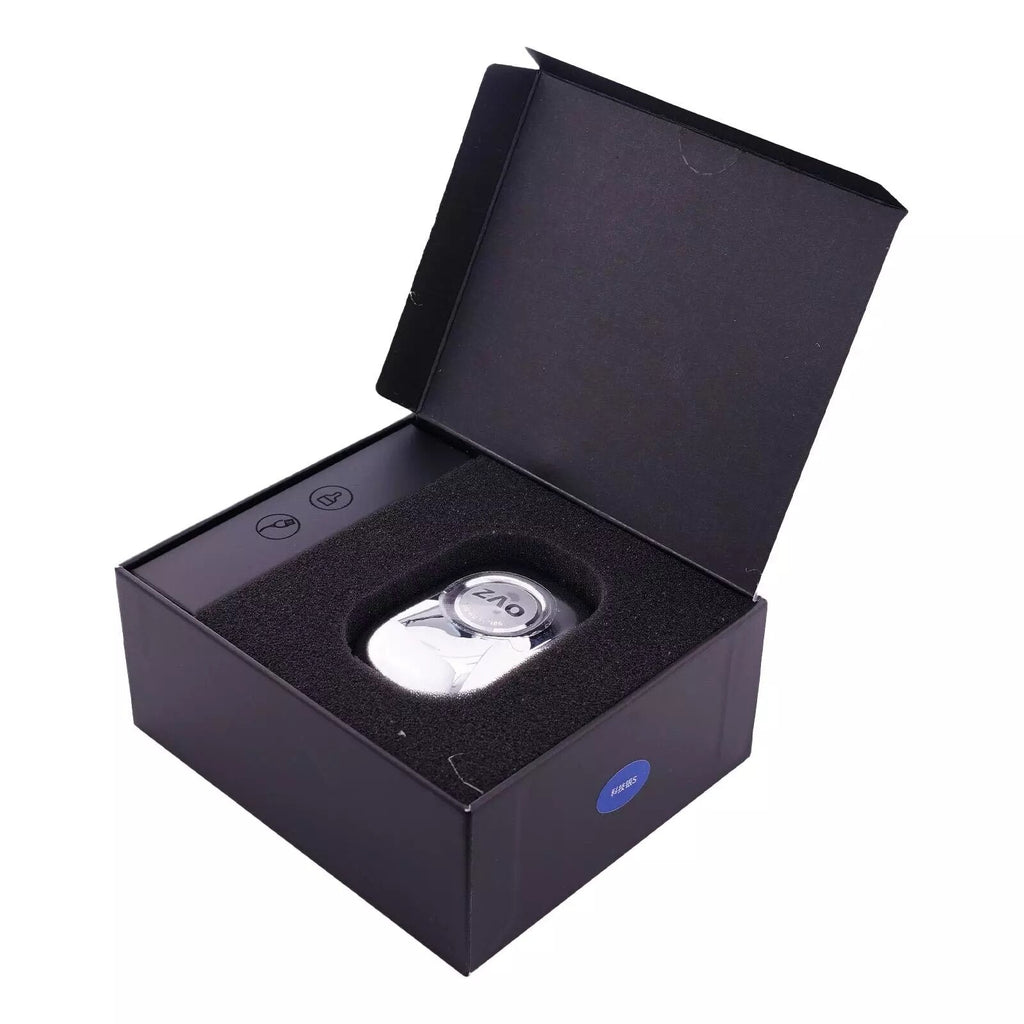 Mini electric shaver in open box, black body with round foil head