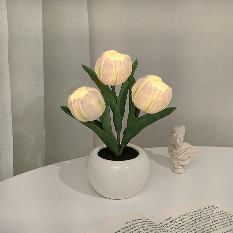 White tulip night light blooms in a white ceramic pot with warm LED glow