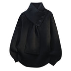 Women’s black knit sweater with attached scarf-style neckline tie and button placket