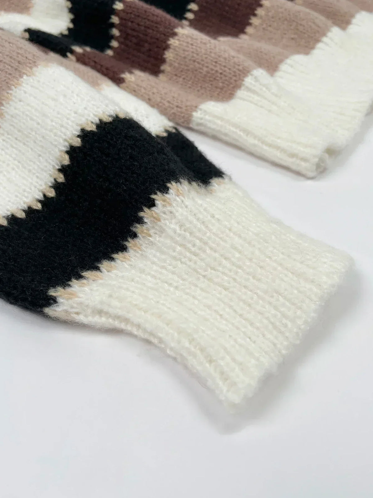 Women’s striped loose knit sweater sleeve in cream, brown, and black