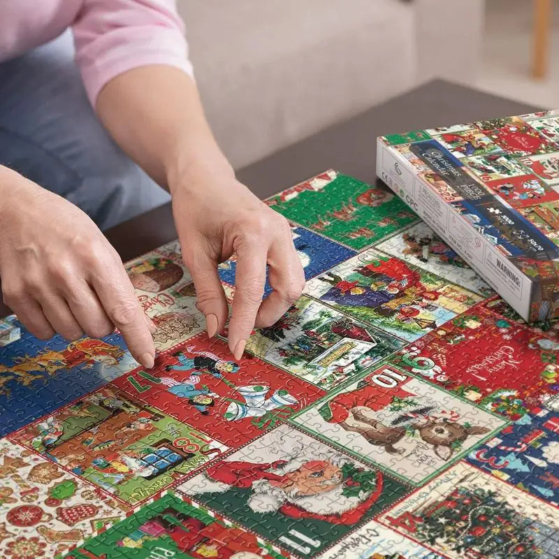 Hands assembling a colorful Christmas jigsaw puzzle on a table