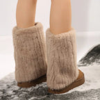Tan knee-high platform lug boots with fluffy faux-fur ankle cuffs and chunky tread soles