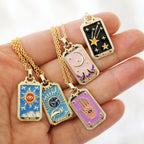 Tarot card pendant necklace set on gold chains with sun, moon, star, and world charms