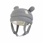 Gray helmet with ear-like features on a light blue background