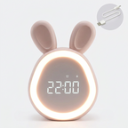 Pink bunny-shaped kids alarm clock with glowing LED ring and 22:00 digital display