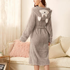 Light gray plush bathrobe with fox-face hood, white muzzle details, tied belt, long sleeves.