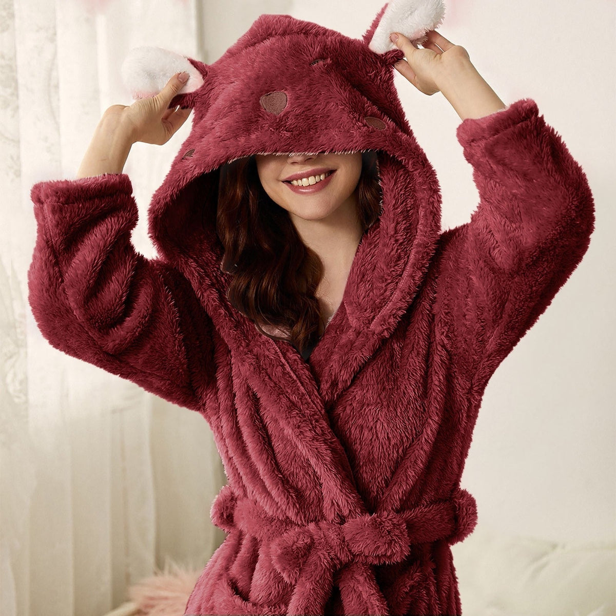 Plush hooded bathrobe in deep red with bunny ears and thick long sleeves, belt tied