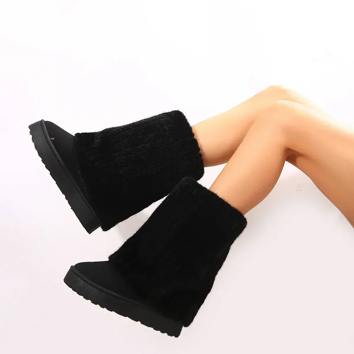 Black knee-high platform lug boots with plush faux-fur uppers and thick tread soles