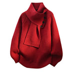 Women’s red knit sweater with attached scarf-style neckline and black button detail