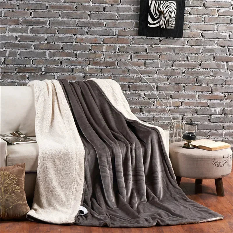 Double-sided flannel and fleece throw, dark gray with cream sherpa border, draped