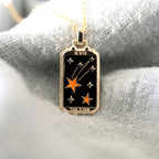 Tarot card pendant necklace with black star card and orange star design on gold chain