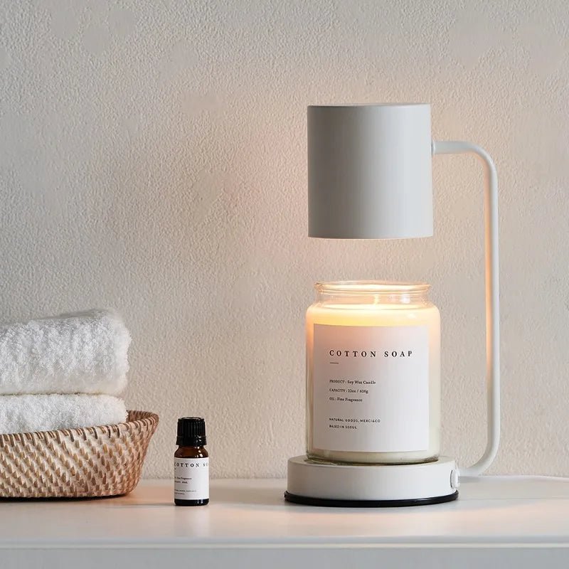 White electric candle warmer lamp with open-top shade over glass jar candle