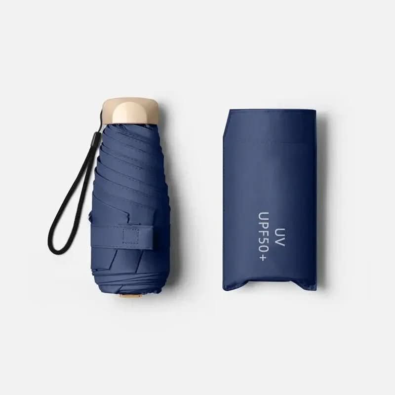 Compact travel umbrella, folded dark blue with wrist strap and protective cover
