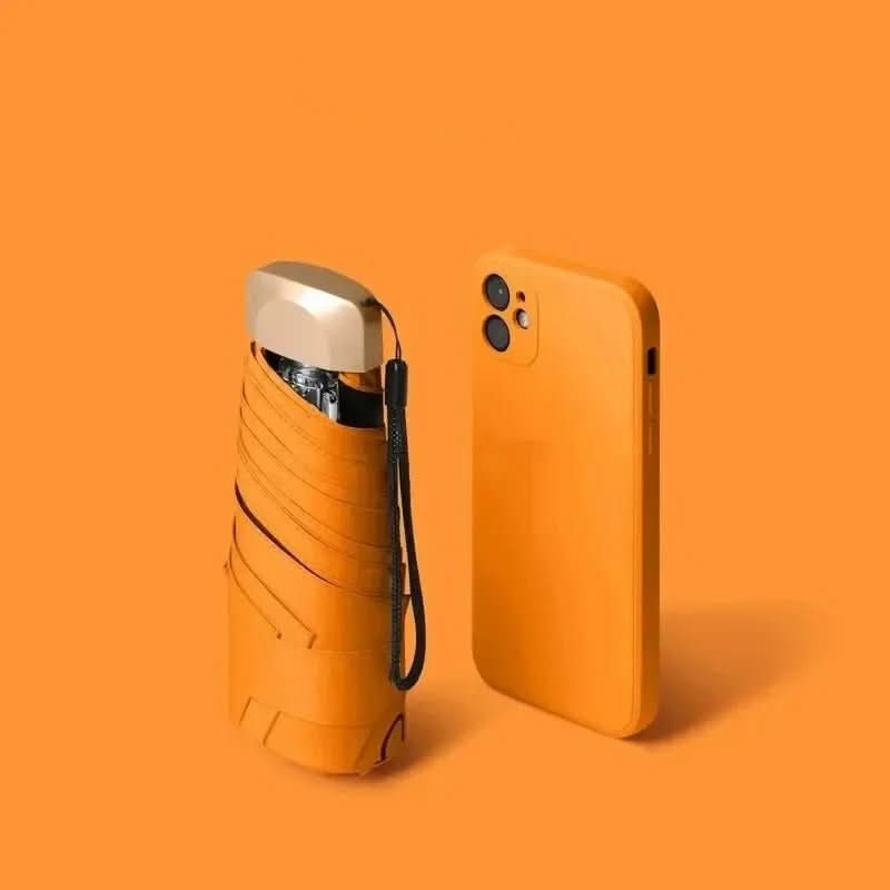 Compact travel umbrella, folded orange with wrist strap and protective cover
