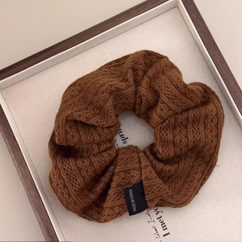 Brown knit oversized hair scrunchie with vintage-style geometric pattern and fabric-covered elastic.