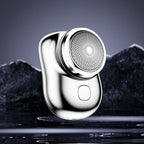Mini electric shaver, silver metallic body with round foil shaving head