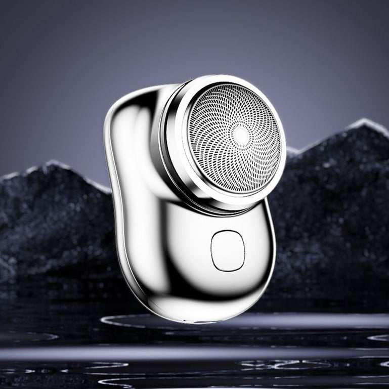 Mini electric shaver, silver metallic body with round foil shaving head