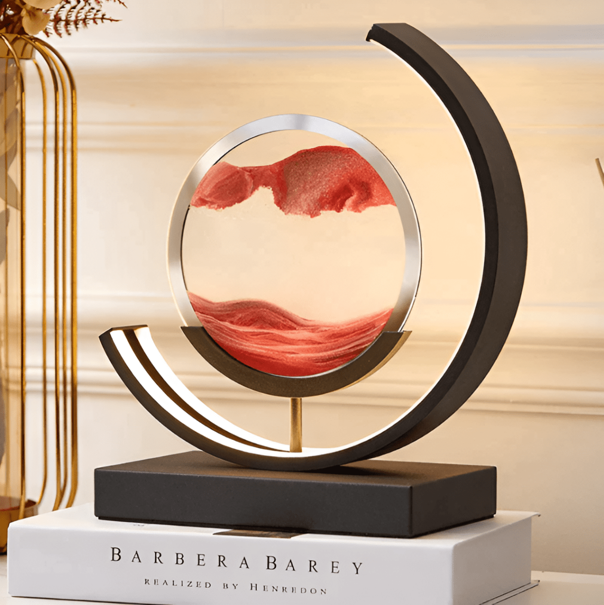 Moving sand LED lamp with circular red sandscape, glowing crescent light ring on stand