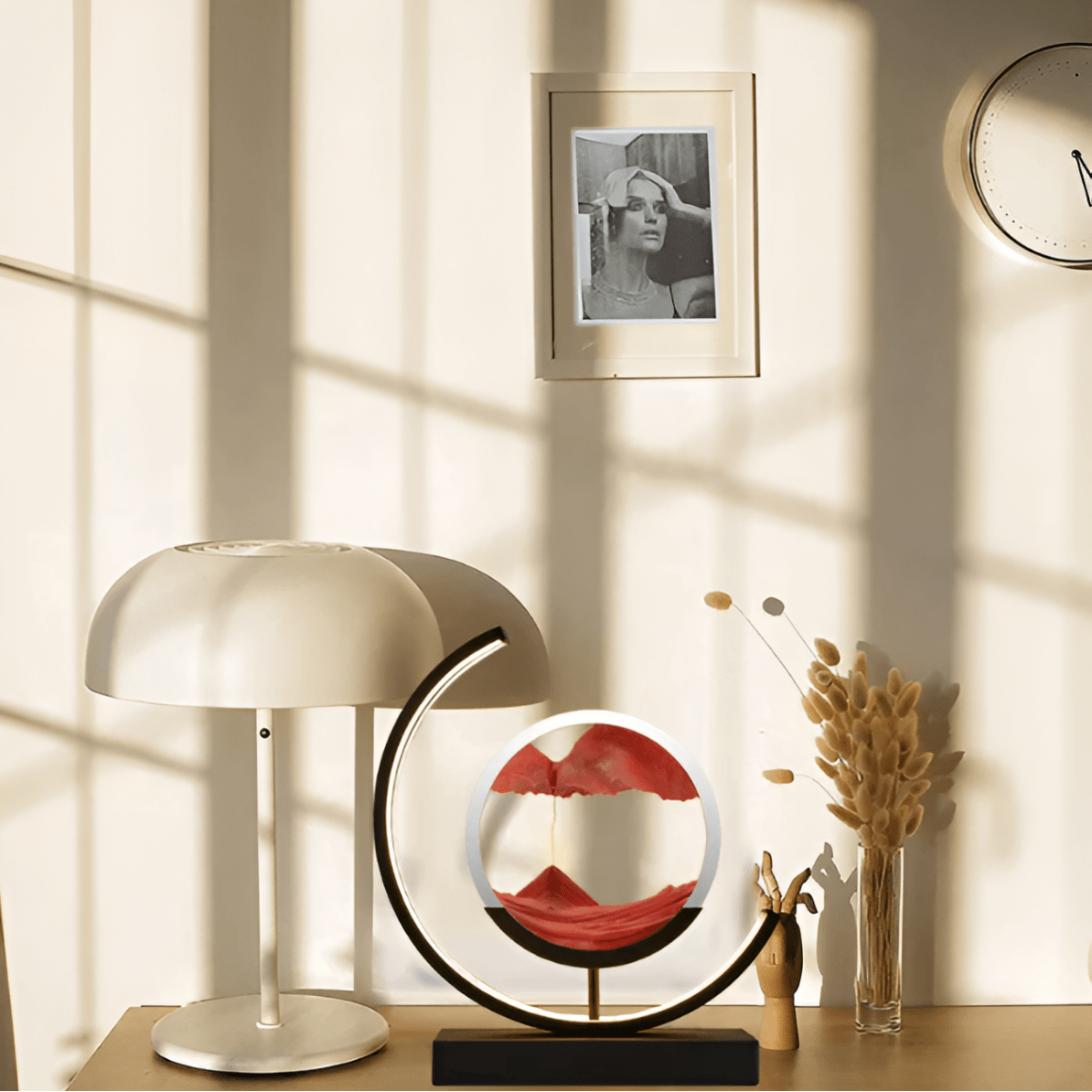 Moving sand LED lamp with circular red sand art and warm white glowing crescent ring base
