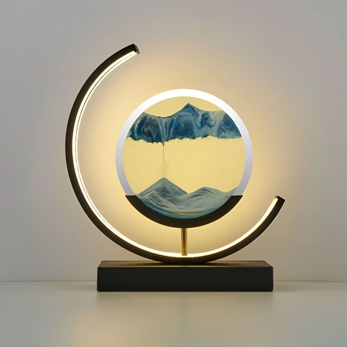 Dimmable moving sand LED lamp with circular blue sand art and glowing crescent ring base