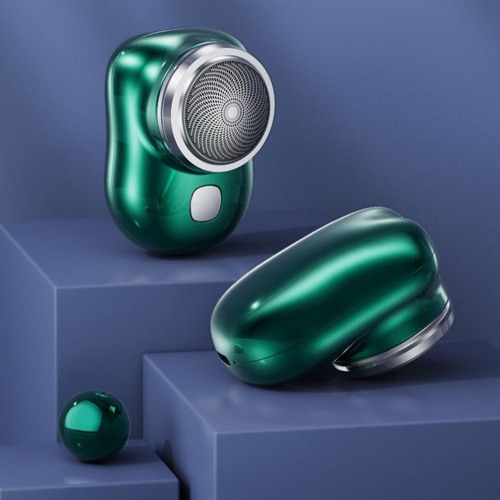 Mini electric shaver, green metallic body with round foil shaving head