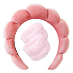 Light pink plush spa headband set with two matching wrist towels for face washing.