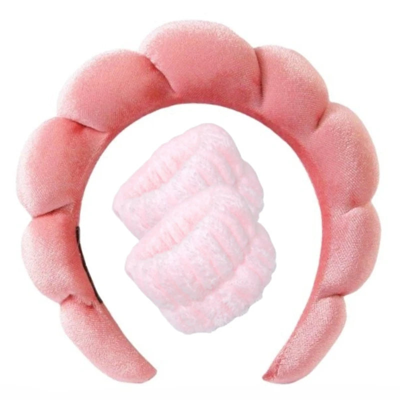 Light pink plush spa headband set with two matching wrist towels for face washing.