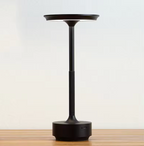 Midnight black cordless LED table lamp with textured center and round base