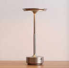 Champagne-gold rechargeable table lamp with warm glowing top and round base