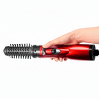 3-in-1 hot air hair brush dryer in hand with red body and round bristle barrel