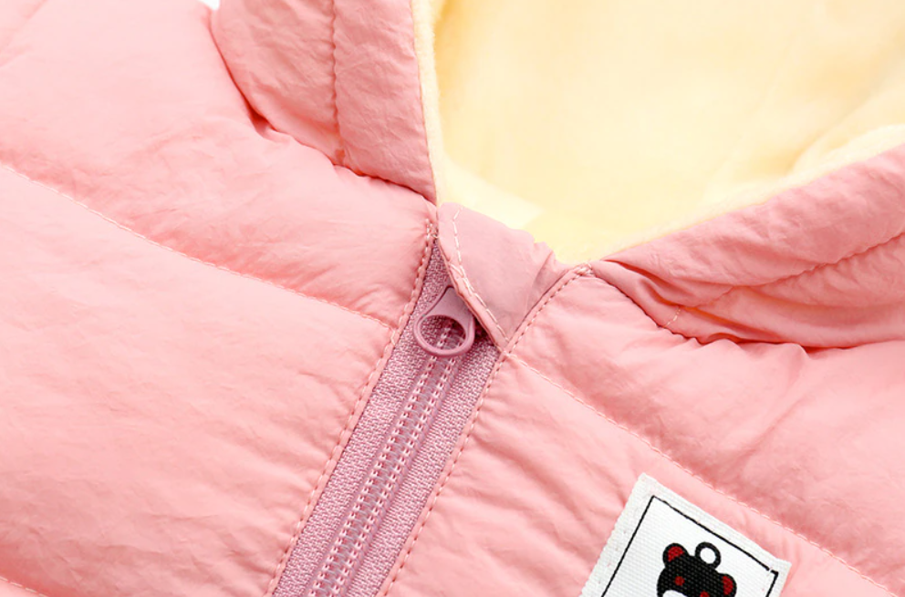 Pink baby snowsuit with front zipper and bear applique patch on chest