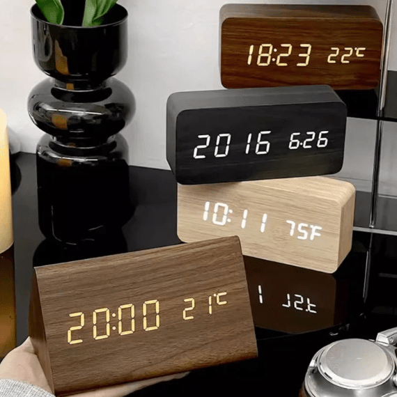 Set of LED wooden digital clocks with orange and white displays on stacked bases