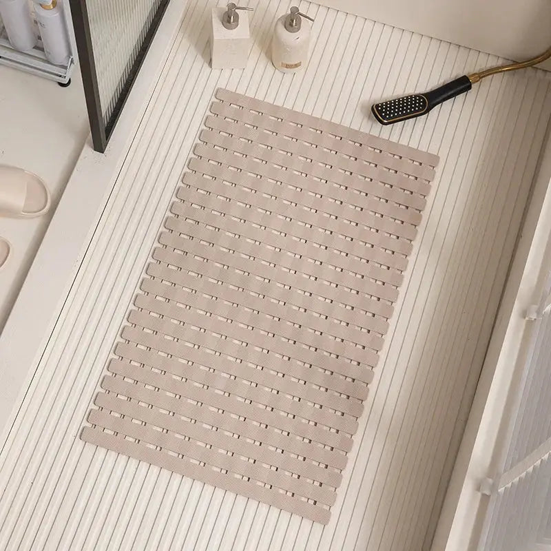 Khaki non-slip bath mat with ridged drainage holes and suction cups, rectangular