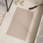 Khaki non-slip bath mat with ridged drainage holes and suction cups, rectangular