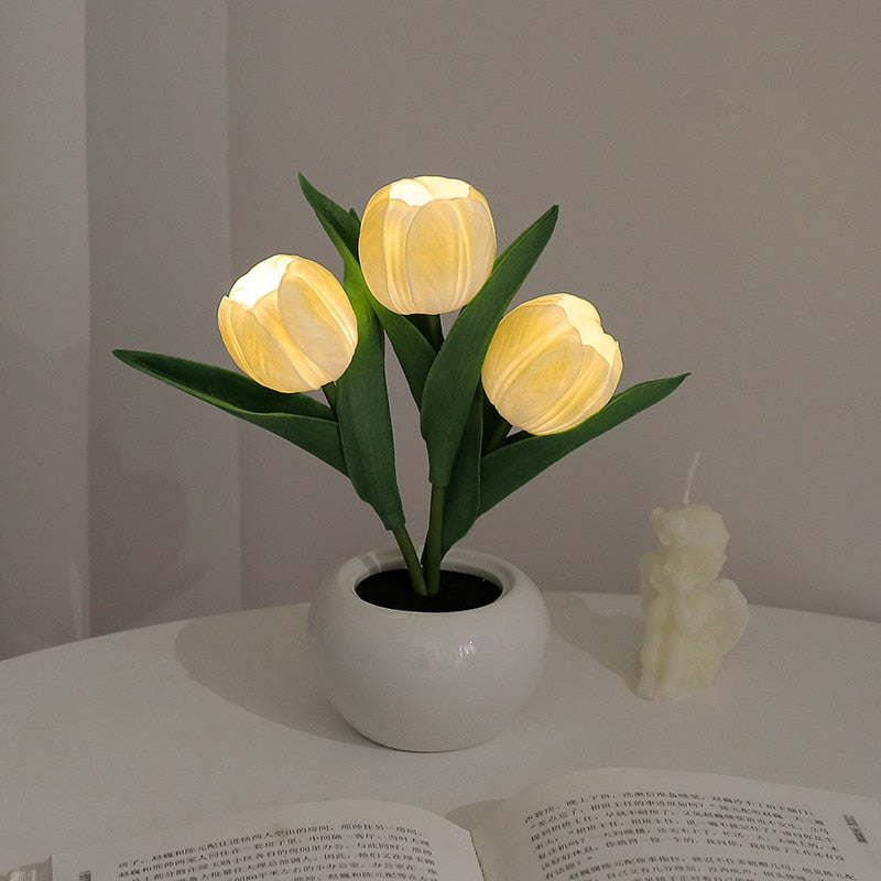 Yellow tulip night light blooms in a white ceramic pot with warm LED glow