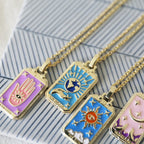 Gold chain tarot pendant necklace with close-up sun, moon, and star card charms