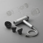 Silver hair dryer with cord, two black magnetic concentrator nozzles, and brush head