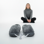 Gray plush heated slippers with power cords, pair with zipper closures