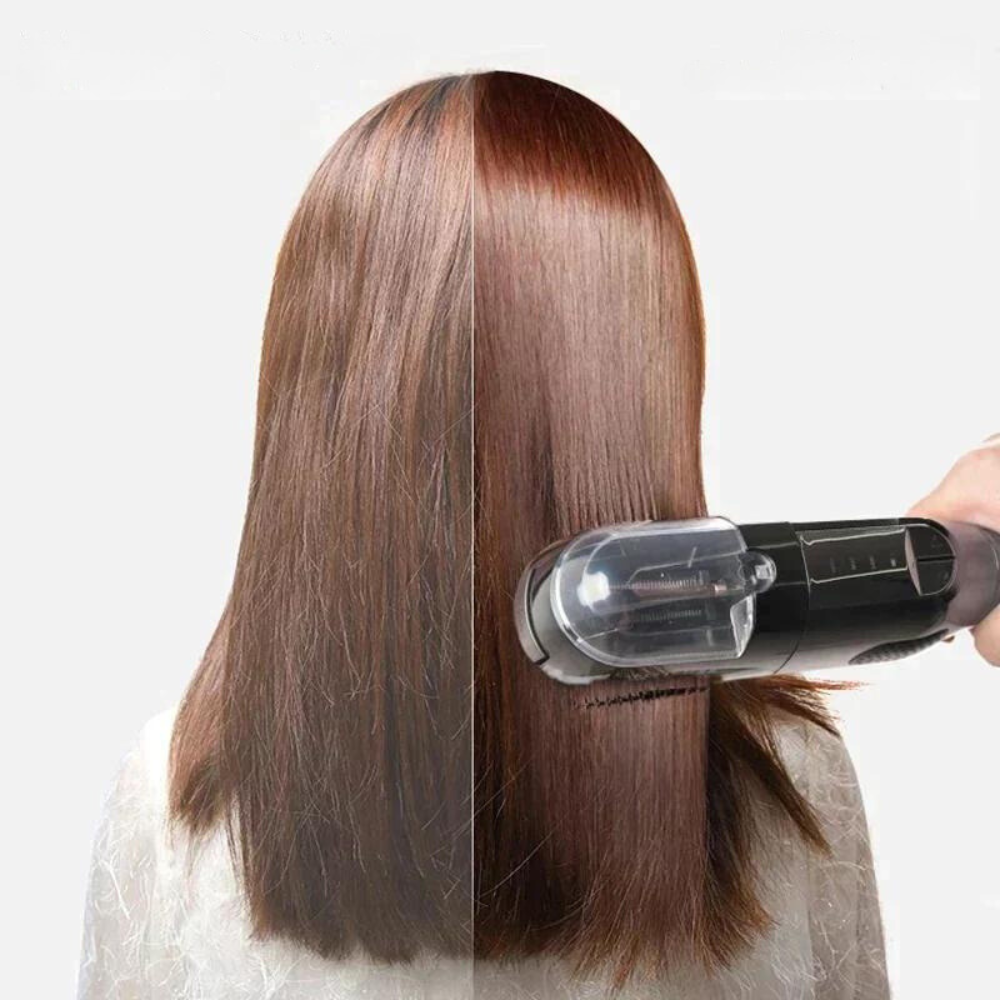 Handheld black split-end hair trimmer with clear cutting chamber, pointed toward hair