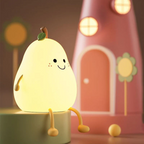 Glowing pear-shaped night light with smiling face and green leaf on small barrel