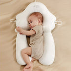 White U-shaped baby support cushion with side handles and a baby resting inside