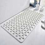 White non-slip shower mat with circular drainage holes and textured anti-slip grip.