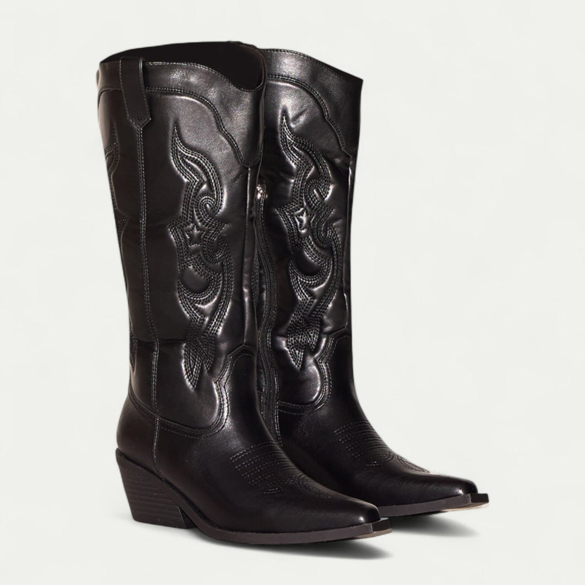 Women's black pointed-toe boots with decorative stitch details and stacked heel