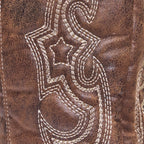 Women's brown boots close-up of ornate white decorative stitching on suede
