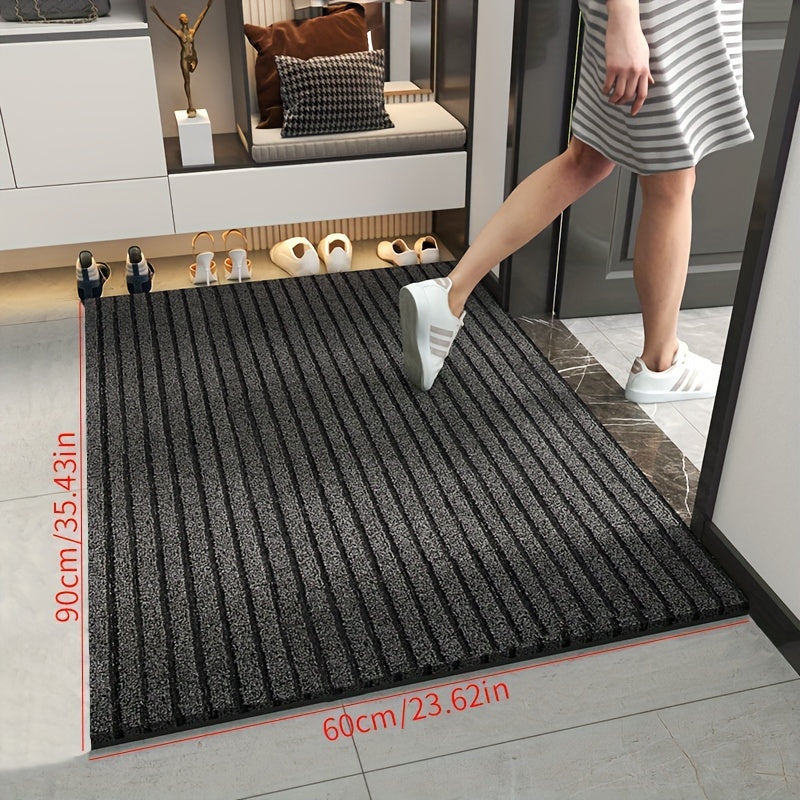 Gray striped doormat in doorway with thick low-pile texture and flat edges