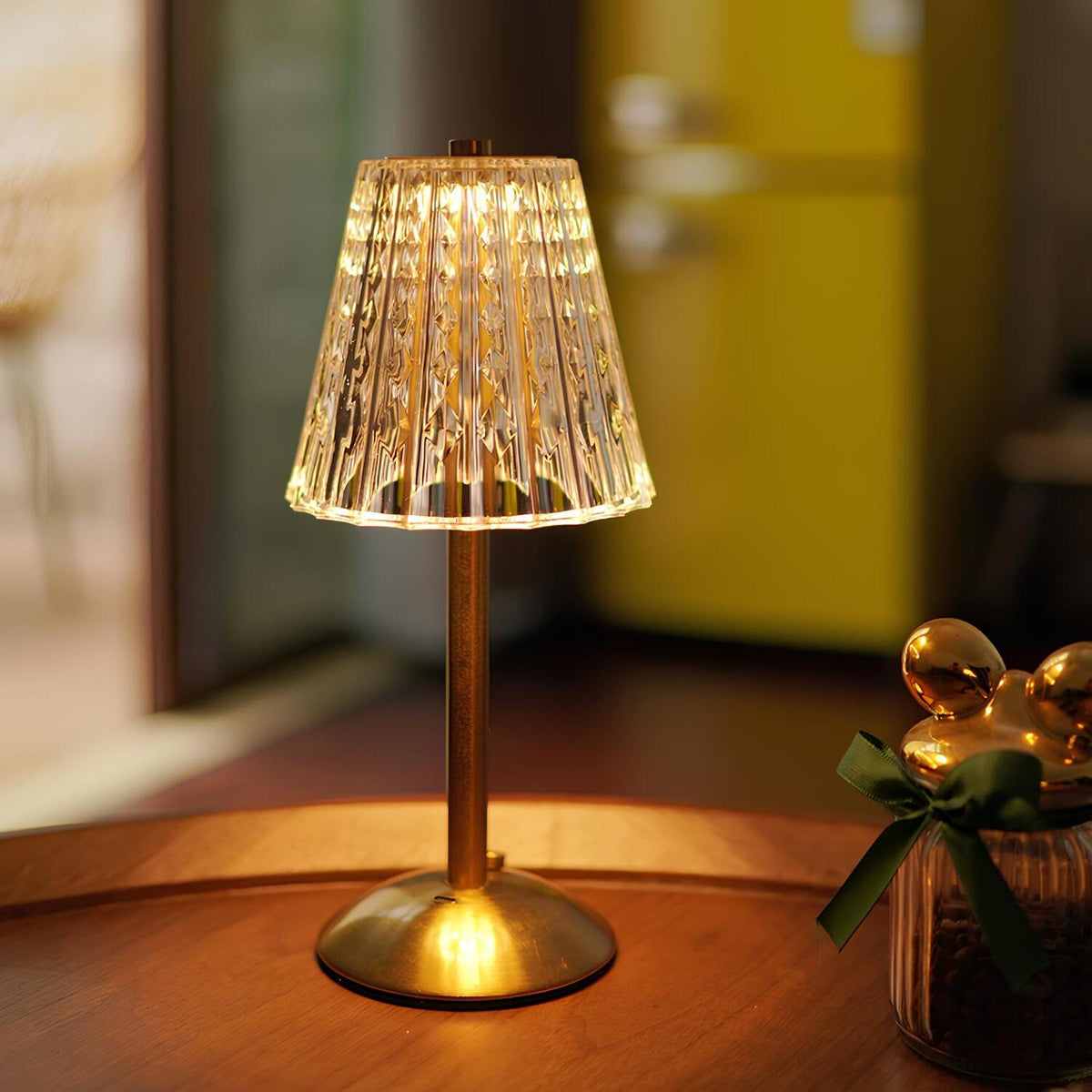 Gold-tinted crystal table lamp with ribbed shade and round metal base