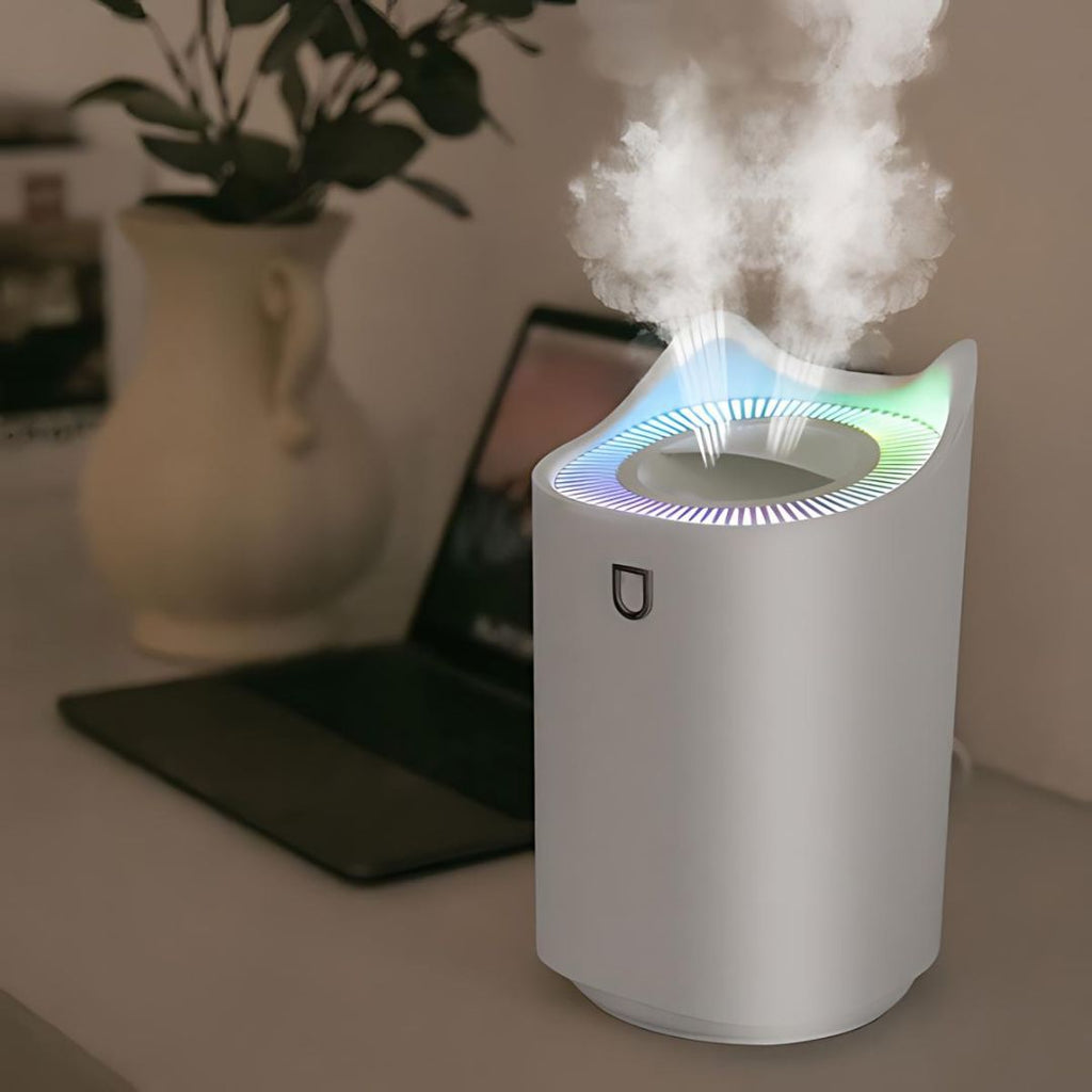 White ultrasonic humidifier emitting cool mist with multicolor LED top