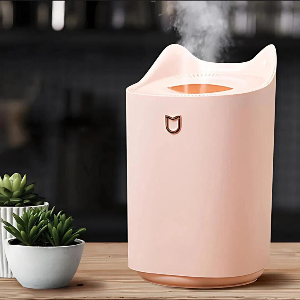 Pink ultrasonic cool mist humidifier with curved top and front mist vent